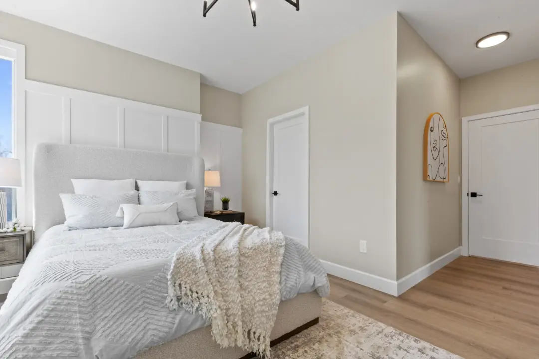 Crofton bedroom with chandelier and board-and-batten feature wall
