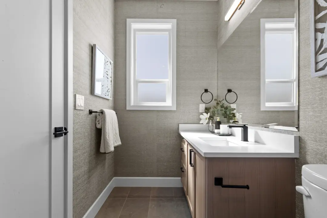 Crofton powder room with linear LED vanity light over mirror