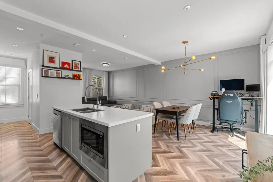 Frame open kitchen and dining with sputnik chandelier and recessed pot lights