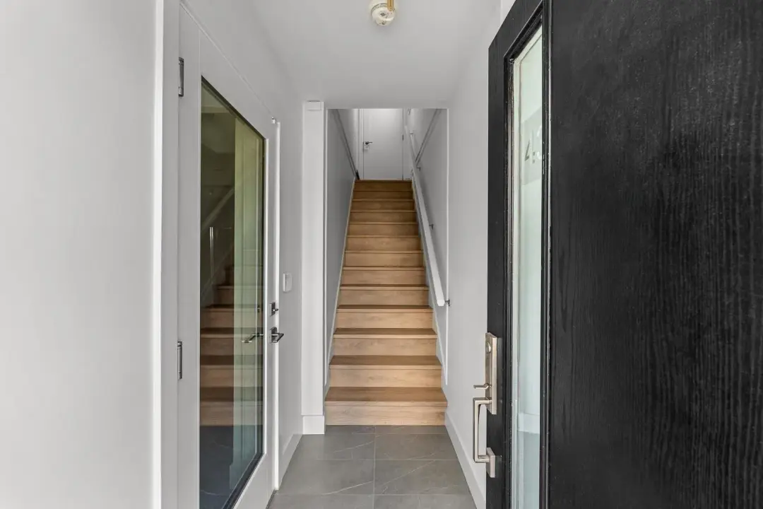Frame entry foyer and stair with smoke detector and wall switch