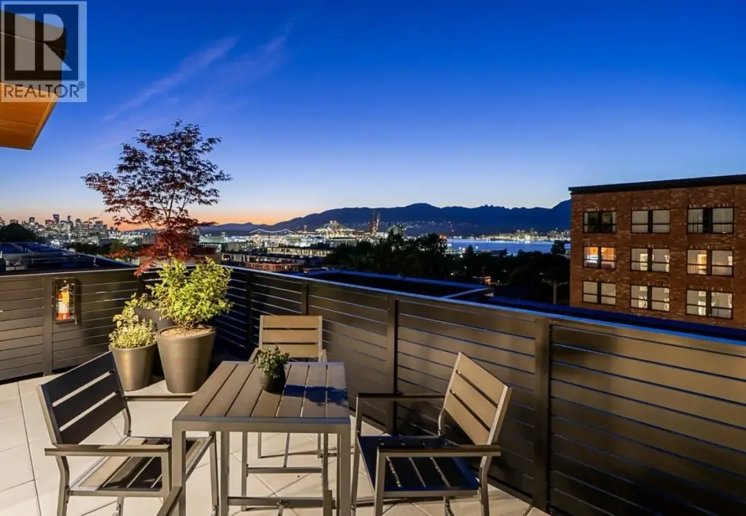 Twilight rooftop patio at Lakewood in Vancouver looking toward the harbour and mountains
