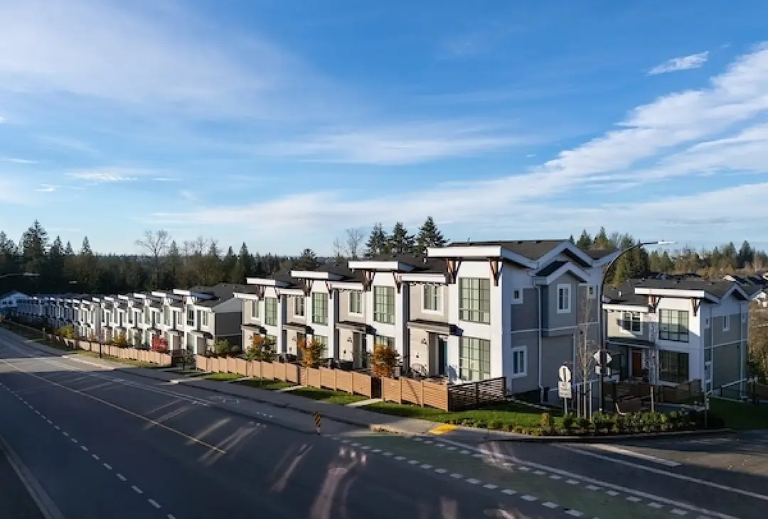Dusk street elevation of Windfall townhome rows in Maple Ridge