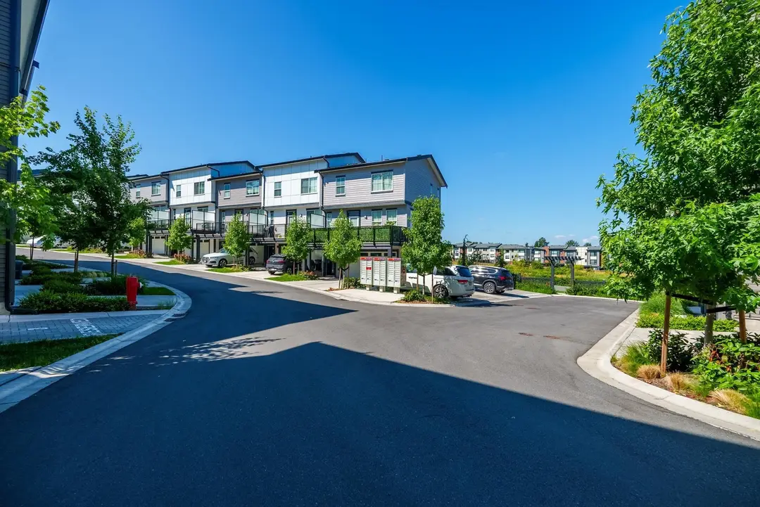 Parallel internal drive with cluster mailboxes and townhome garages in Langley