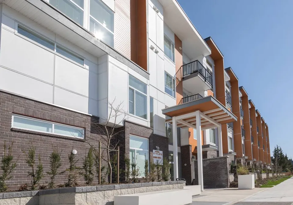 Phoenix Citylife entrance canopy in Surrey, with a project plaque beside the doors