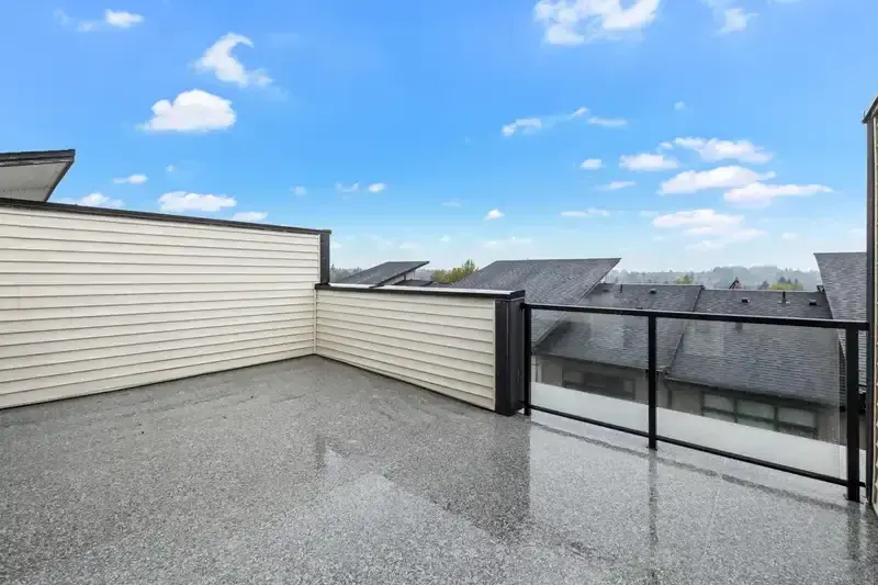 Summit empty rooftop deck with glass railing and neighbourhood view