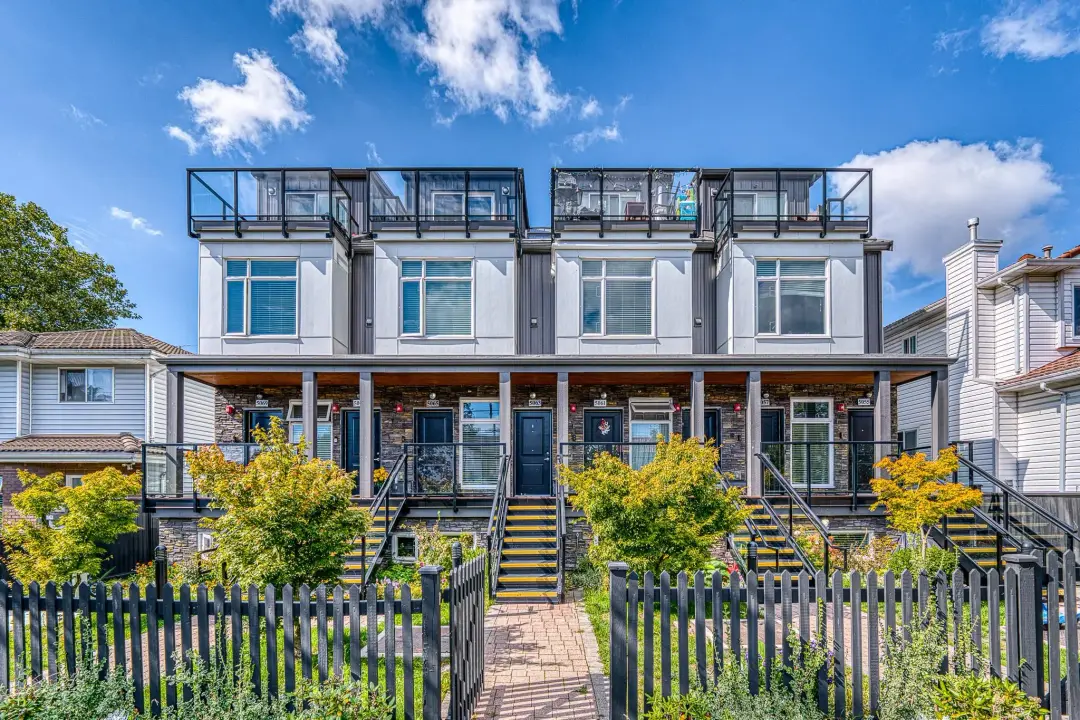 Street facade of Earles townhomes in Vancouver with stone base and rooftop decks