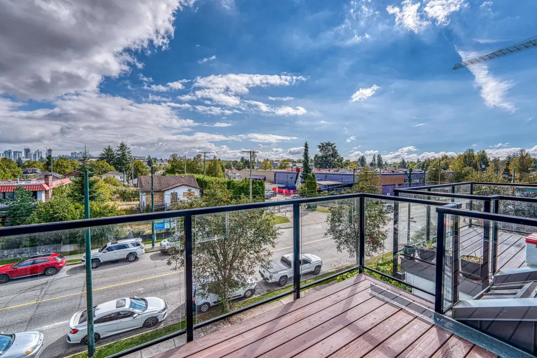 Earles balcony view toward Vancouver skyline with glass railing
