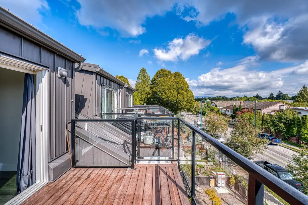 Earles upper balcony with charcoal metal siding and exterior wall light