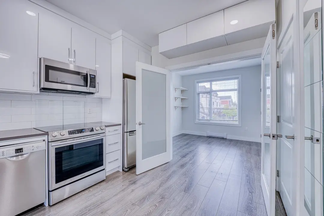Earles kitchen with recessed lighting and frosted-glass den doors