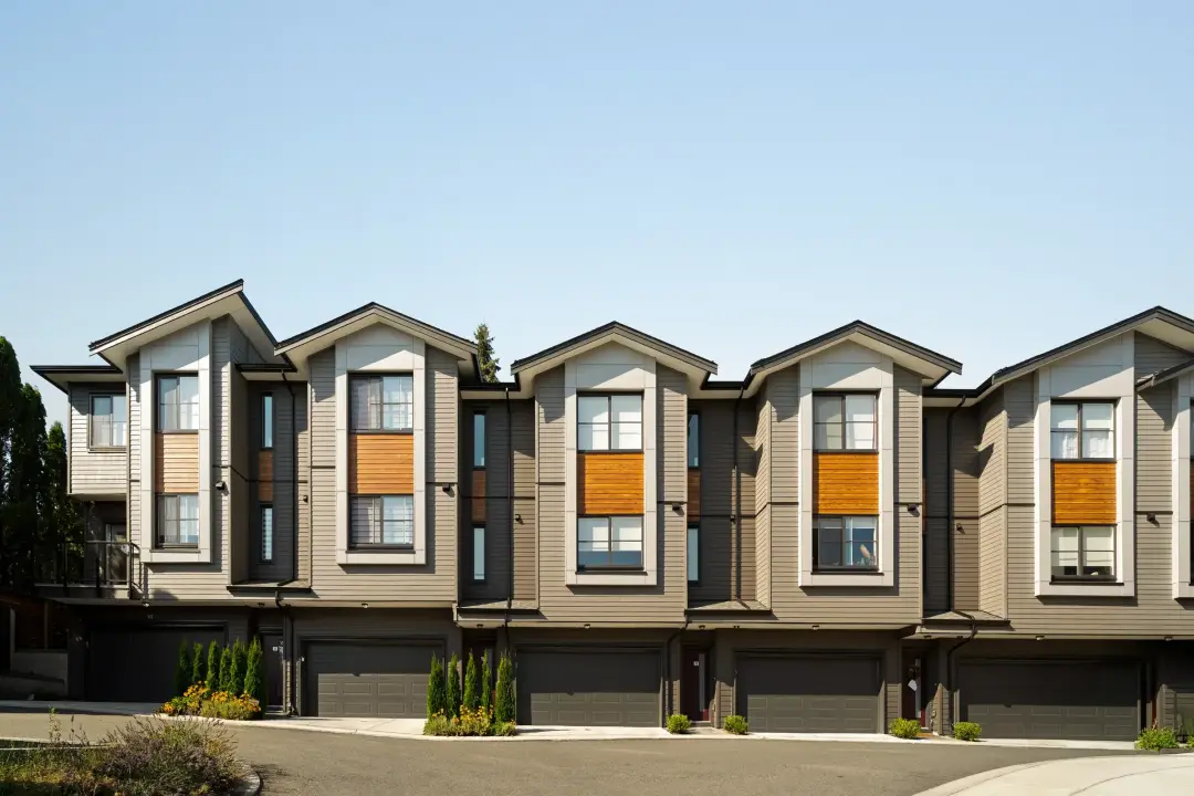 Row of modern Elwynn Green townhomes with grey siding and wood accents in Surrey BC