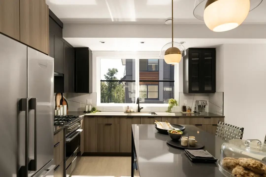Elwynn Green show-suite kitchen with recessed LED pot lights and pendant lighting