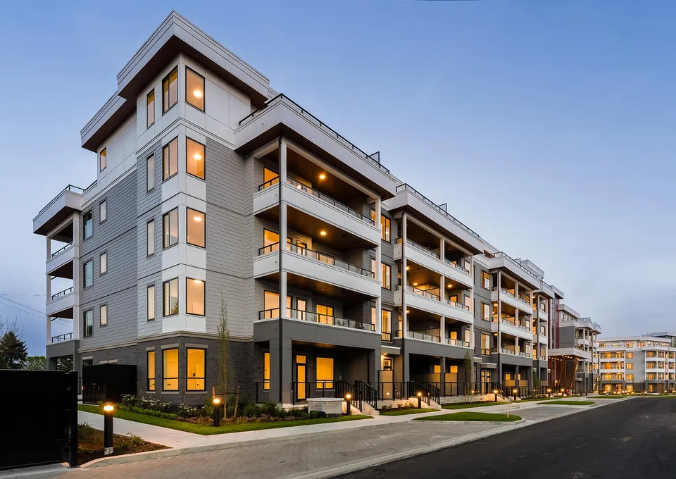 Park & Maven urban homes mid-rise dusk exterior with balcony soffit lighting
