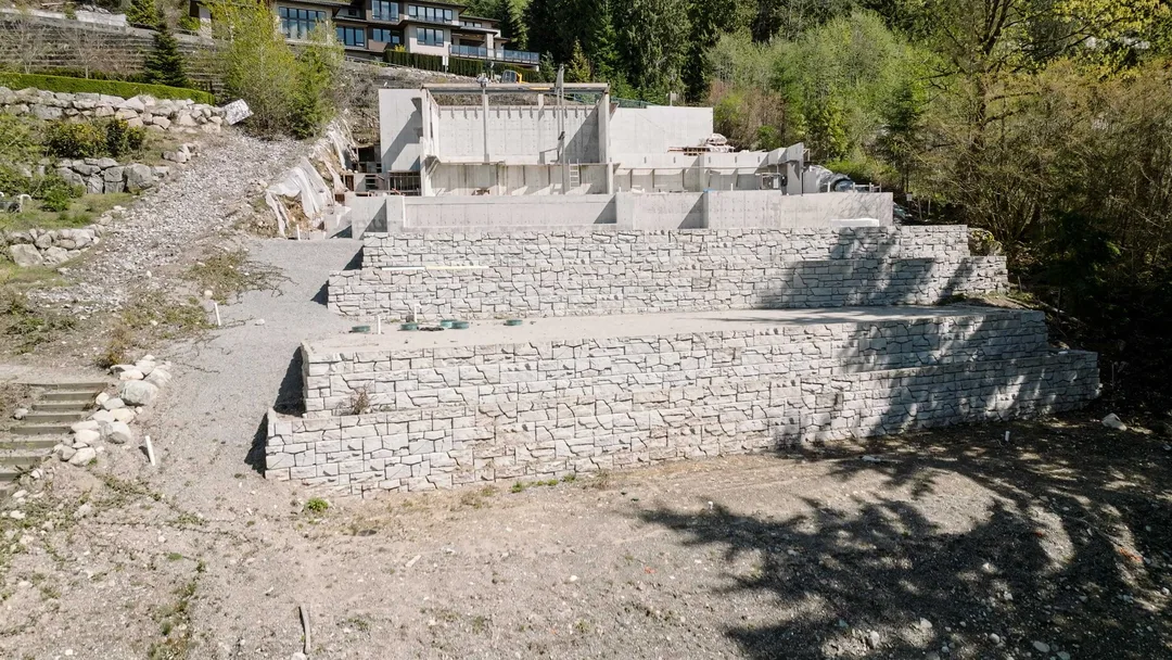 Chauhan Anmore — stone retaining wall and foundation at the custom home site
