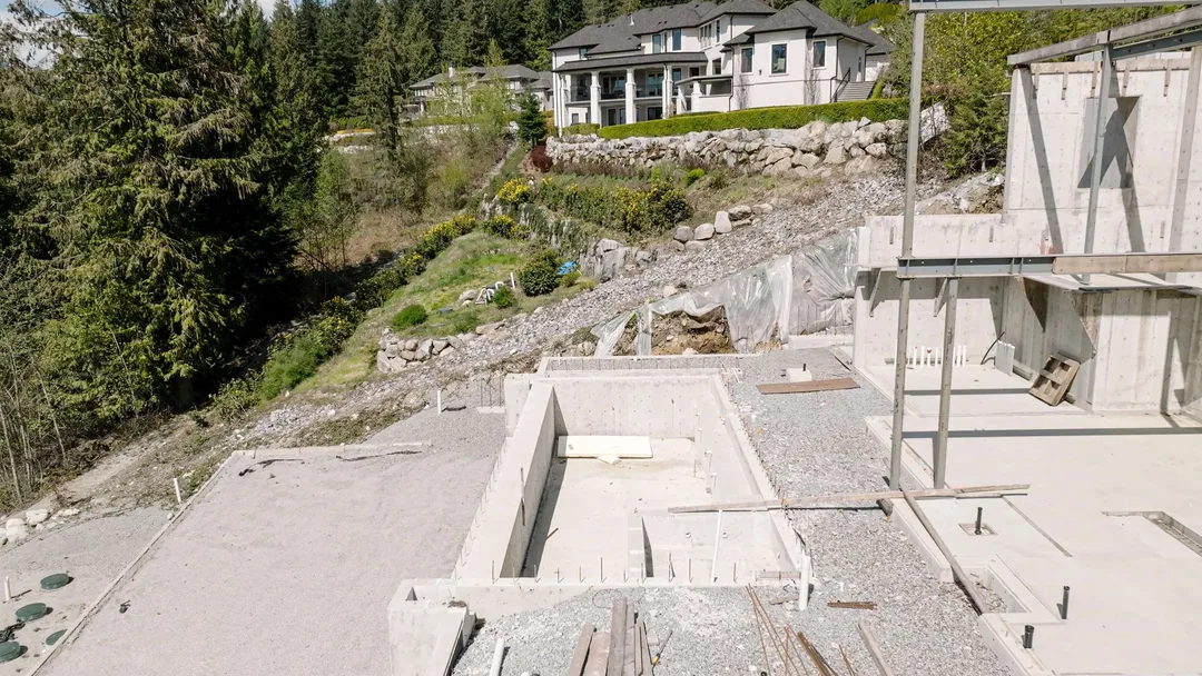 Chauhan Anmore — pool foundation looking toward the uphill neighbour