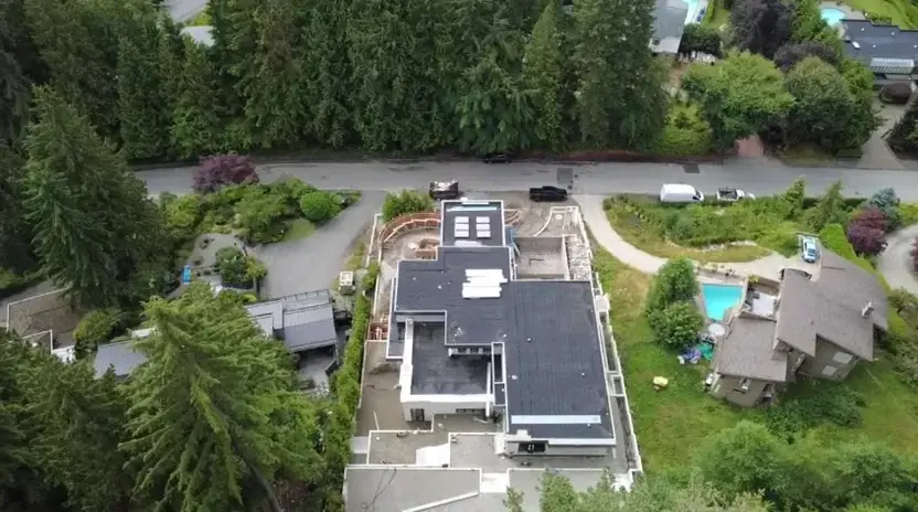 Aerial roof plan view of Millstream West Vancouver custom home construction amid evergreens