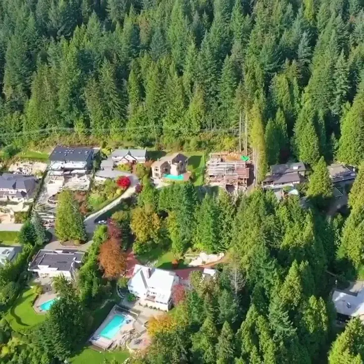Aerial neighbourhood context of Millstream custom home under construction in West Vancouver forested hillside